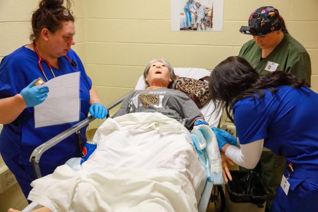 Phlebotomy Technicians working on a healthcare dummy